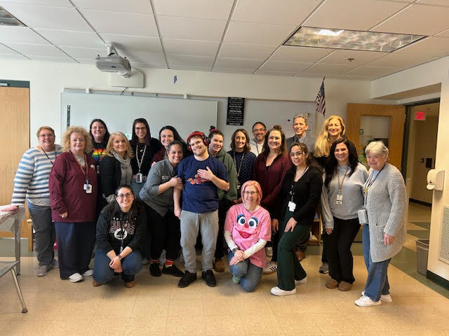 Postgraduate Jay Jay Michaud poses with the Special Education staff and Principal Sean Bevan for a picture during Michaud’s CAP graduation on March 7. 
