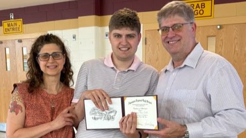 Postgraduate Andreas Bello is awarded his certificate, showing his graduation from Algonquin’s CAP program. Bello stands with his family, posing for a photo after he receives his diploma.