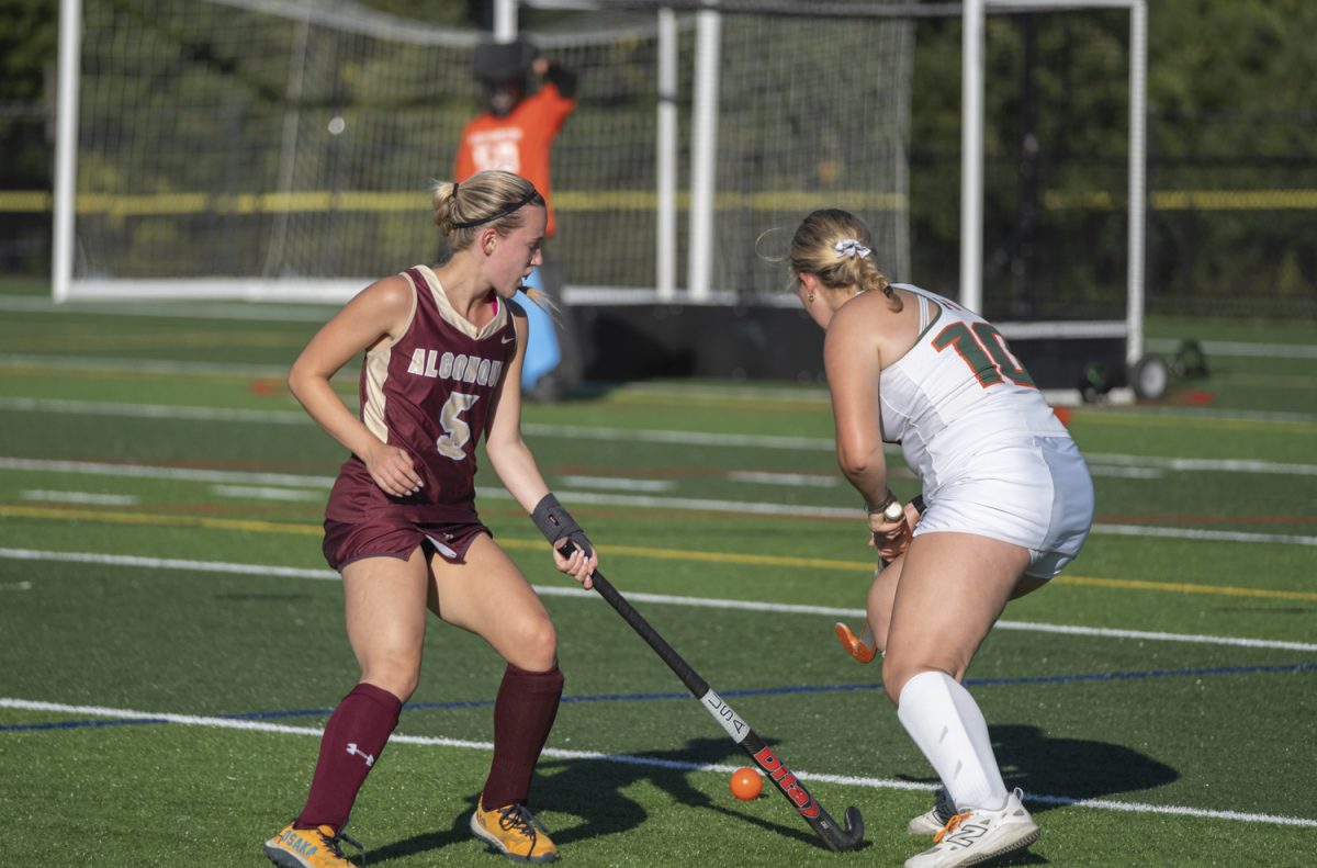 Senior Taylor Mieth takes the ball away from the opposing team during the first quarter of the field hockey.