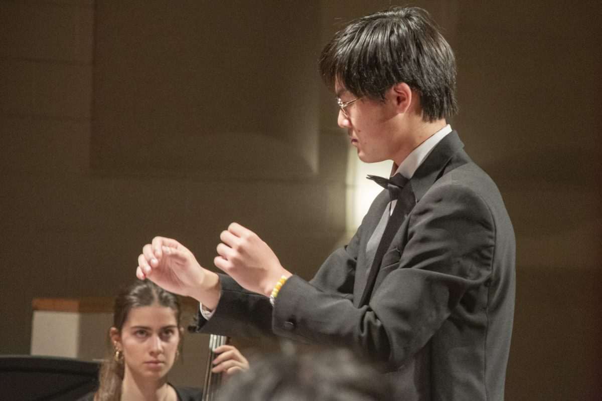 Senior Aaron Wu conducts the String Orchestra while they play "Canzone Sotto Le Stelle," “Song Under the Stars."