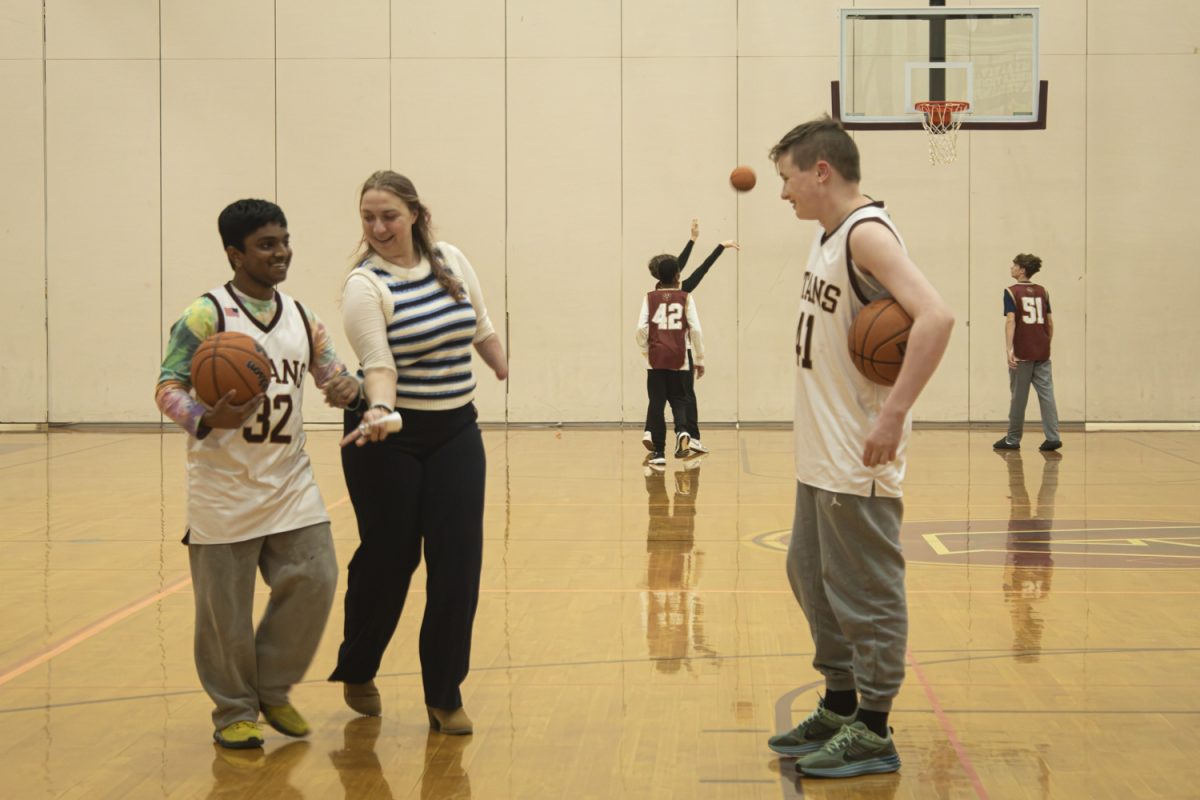 Educational Support Professional Stefani Giegucz practices with the unified basketball team before their game.