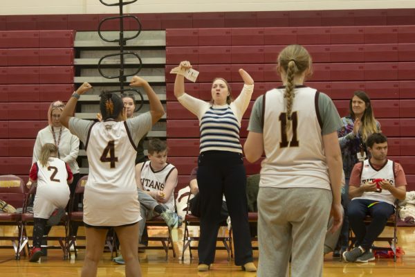Stefani Giegucz, coaches the unified basketball team. Cheering with her student who just scored a point.