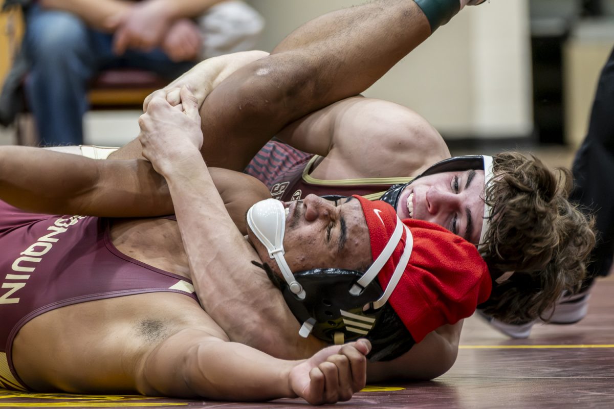 Junior Victor De Oliveira is pinned down in a cradle by a Sheppard Hill opponent during the wrestling meet on Jan. 7.