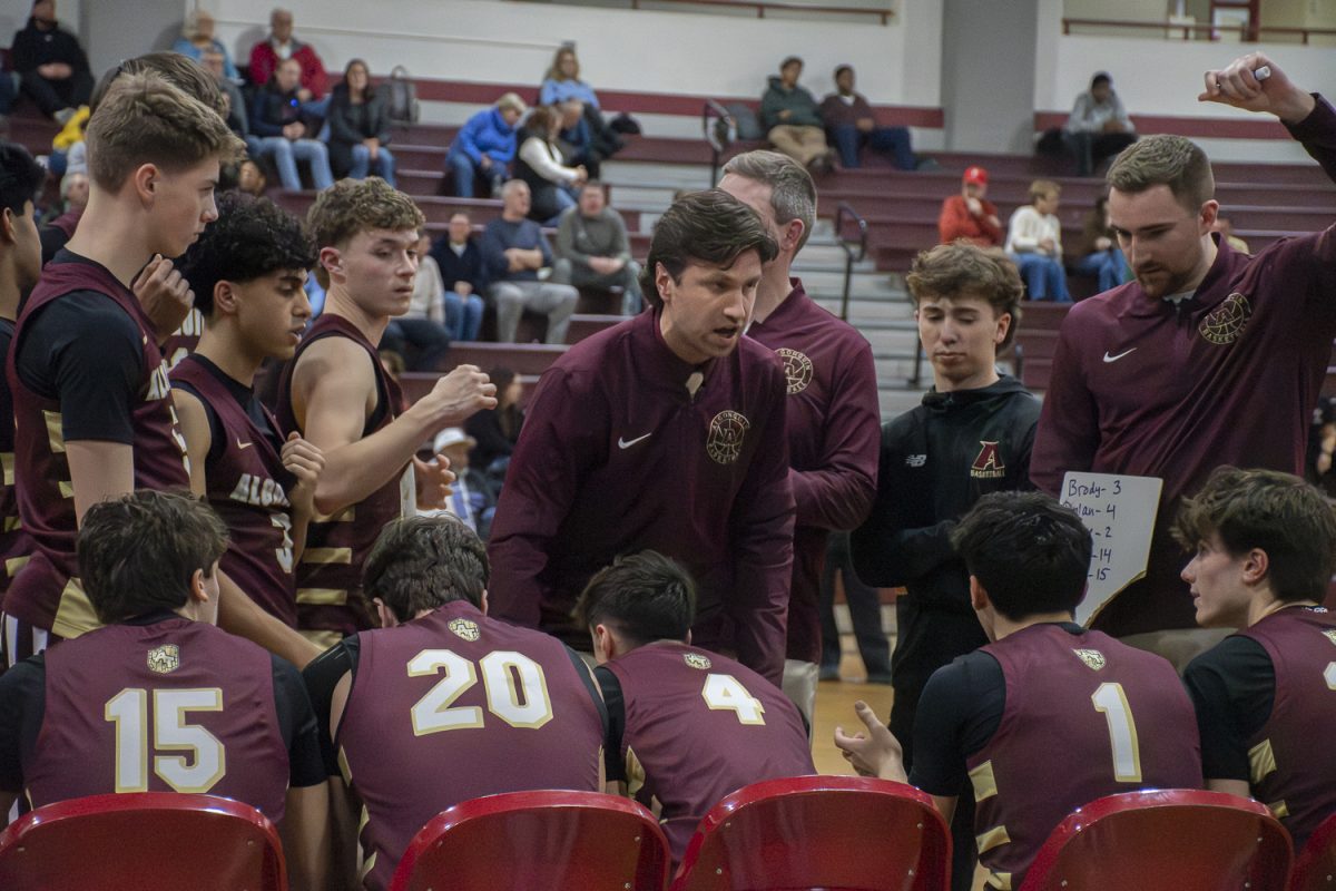 Head Coach Andrew Kinney addresses the team before tip off during the boys' basketball away game against Fitchburg on Jan. 9.