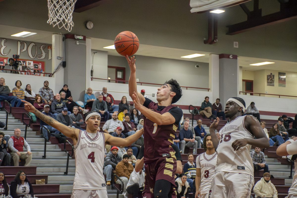 Senior Brody Faessler goes up for a lay up during the boys' basketball away game against Fitchburg on Jan. 9. Algonquin lost with a final score of 42-54.