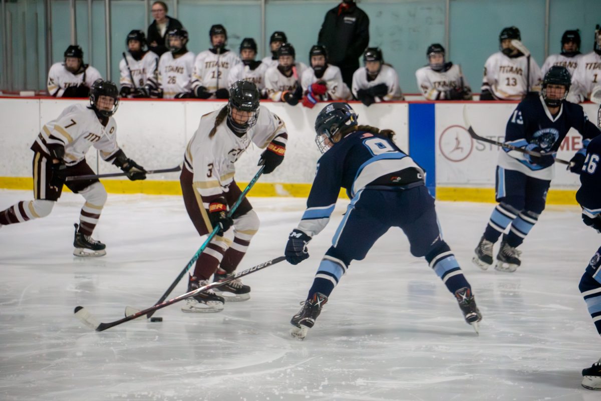 Freshman Alexandra Joslyn brings forward the puck during the girls’ hockey 8-0 win against Franklin on Feb. 9.