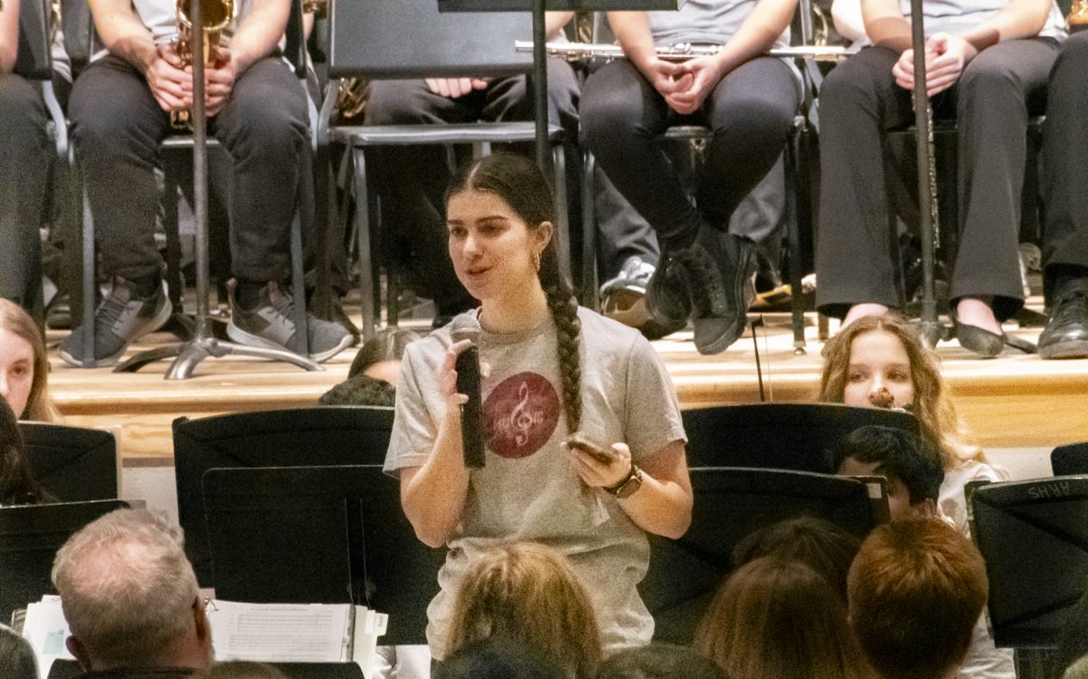 Senior Laura White gives a speech during the NSBoro Connect Concert on Feb. 10, speaking about her experience being involved with the Algonquin music program to help the upcoming freshmen in attendance know what to expect and look forward to.