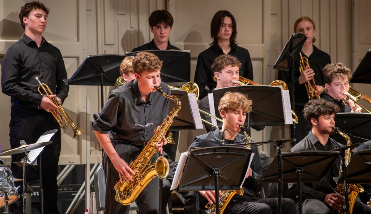 Freshman Miles Koning finishes off Jazz Night by playing a solo on the tenor saxophone on March 16. Four bands, including two from the district's middle schools, performed during Jazz Night.