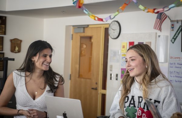 Ladies First a cappella group leaders seniors Ava Guckian and Emily Ruiz address members during an after-school rehearsal on April 9. The seniors, who have been in the group since freshman year, aim to serve as leaders and role models like those they once had.