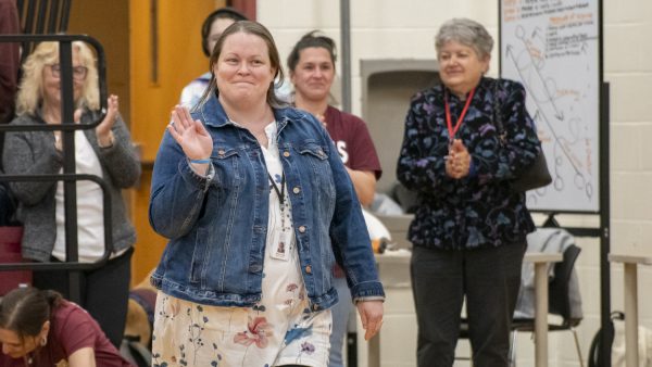 Applied arts teacher Susan Muise waves to cheering students when she is announced as the winner of the Pat Carlson teacher of the year award during the assembly on May 8.