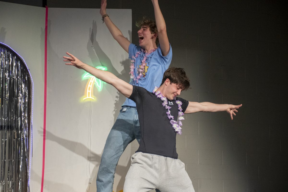Junior Ben Dane and senior Jared Lebel celebrate their characters winning the “Love Island” sketch during the Dog Days of Improv show on May 14. Throughout the show, members of the improv troop acted out a sketch that was broken up by various improv games.