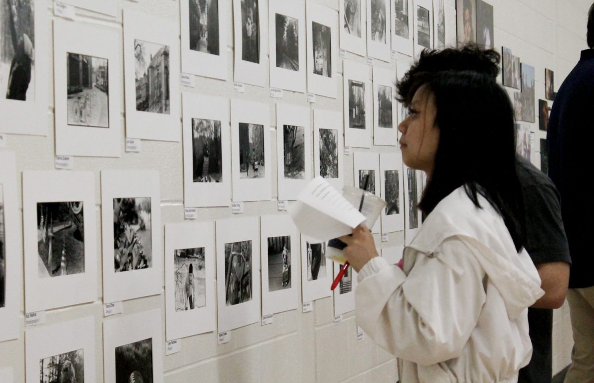 Along with their friends and family, students attend the art show and admire their own works.