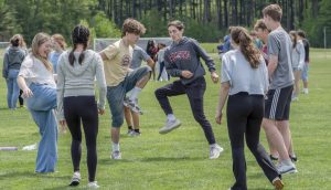 During Carnival on May 22, junior AJ Phaneuf, senior Dylan Steele and other students form a circle and kick around a hacky sack trying to keep it off the ground.