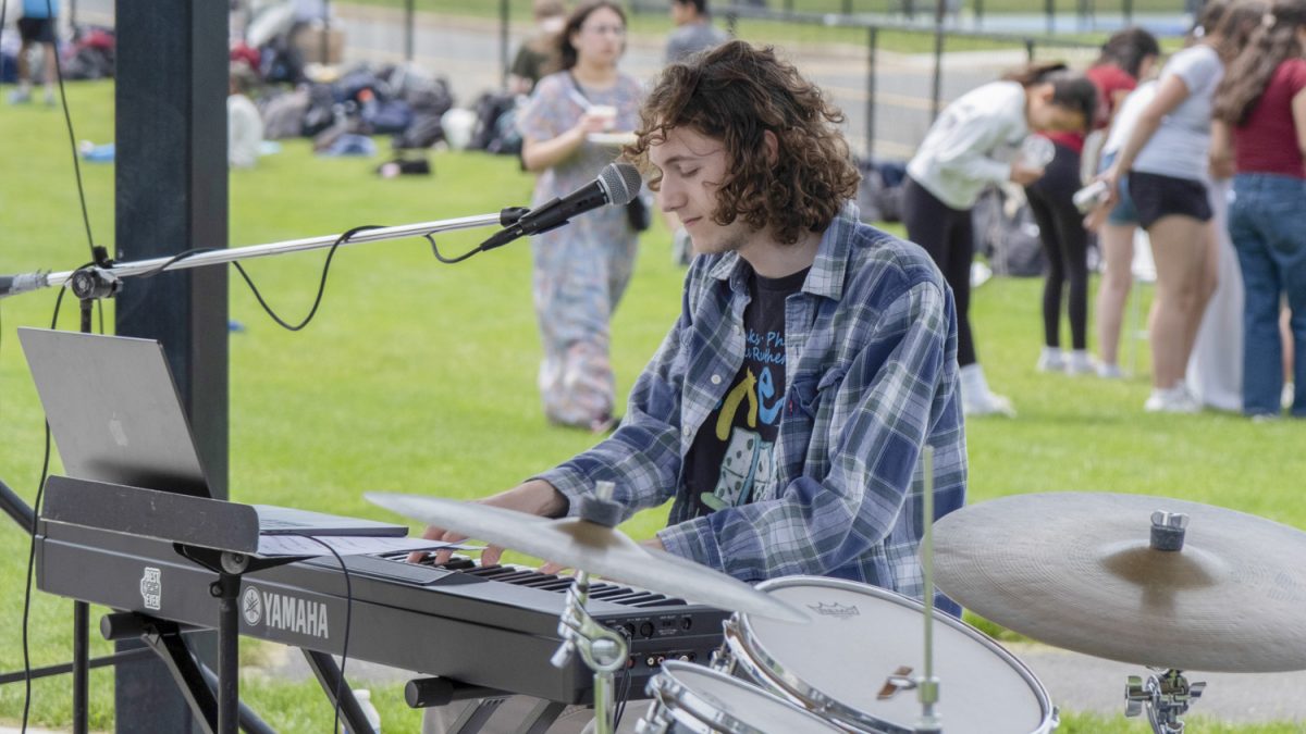 Senior Thomas Schuler plays the piano and sings during his performance at Carnival on May 22.