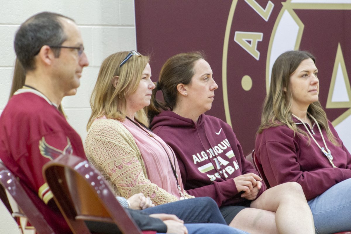 Previous Pat Carlson Teacher of the Year winners social studies teachers Nathaniel Uttaro, Kathleen Salt and Brittany Burns, and health and fitness teacher Kristen Morcone watch as Principal Sean Bevan gives a speech. He announced this year’s Teacher of the Year recipient on May 8.