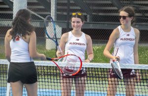 At the end of the girls’ tennis doubles match on May 19, sophomores Clara Campbell and Sarah Campbell tap rackets with their opponent.
