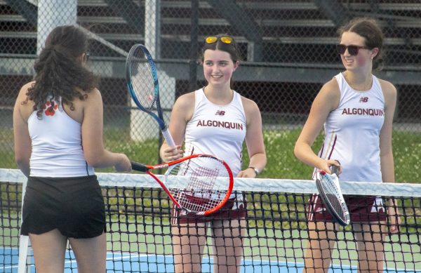 At the end of the girls’ tennis doubles match on May 19, sophomores Clara Campbell and Sarah Campbell tap rackets with their opponent.