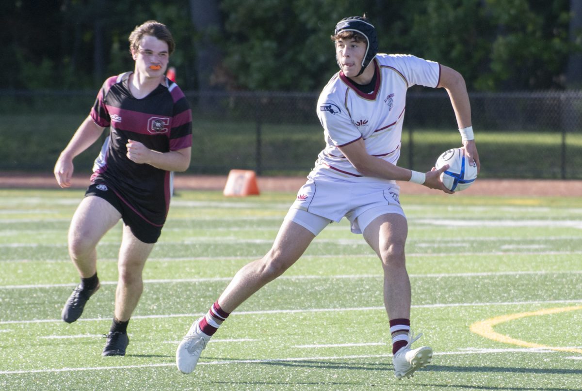Junior Jack Wallace passes to his teammate during the boys’ rugby win against Chelmsford on May 28.
