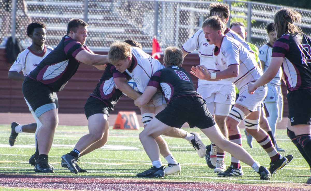 Junior Will Johnston attempts to push through Chelmsford opponents during the boys’ rugby 47-19 win on May 28.