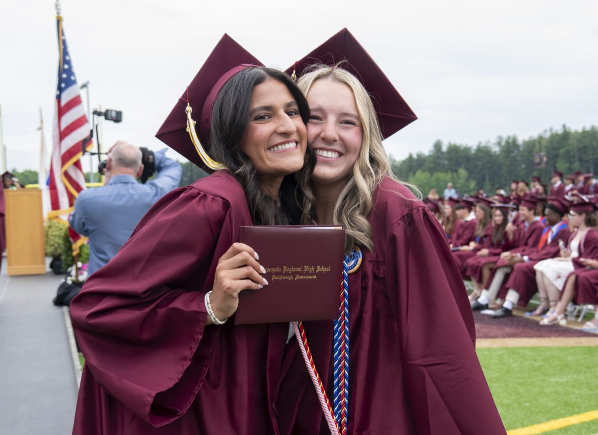 Seniors Emily Ruiz and Sydney Roy pose together for family members after receiving their diplomas at graduation on June 6.
