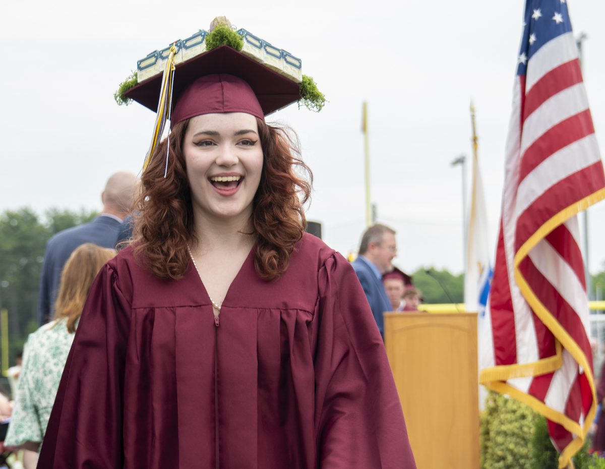 After walking the stage and accepting their diploma, senior Linden Schaffer smiles at family in the crowd at graduation on June 6.