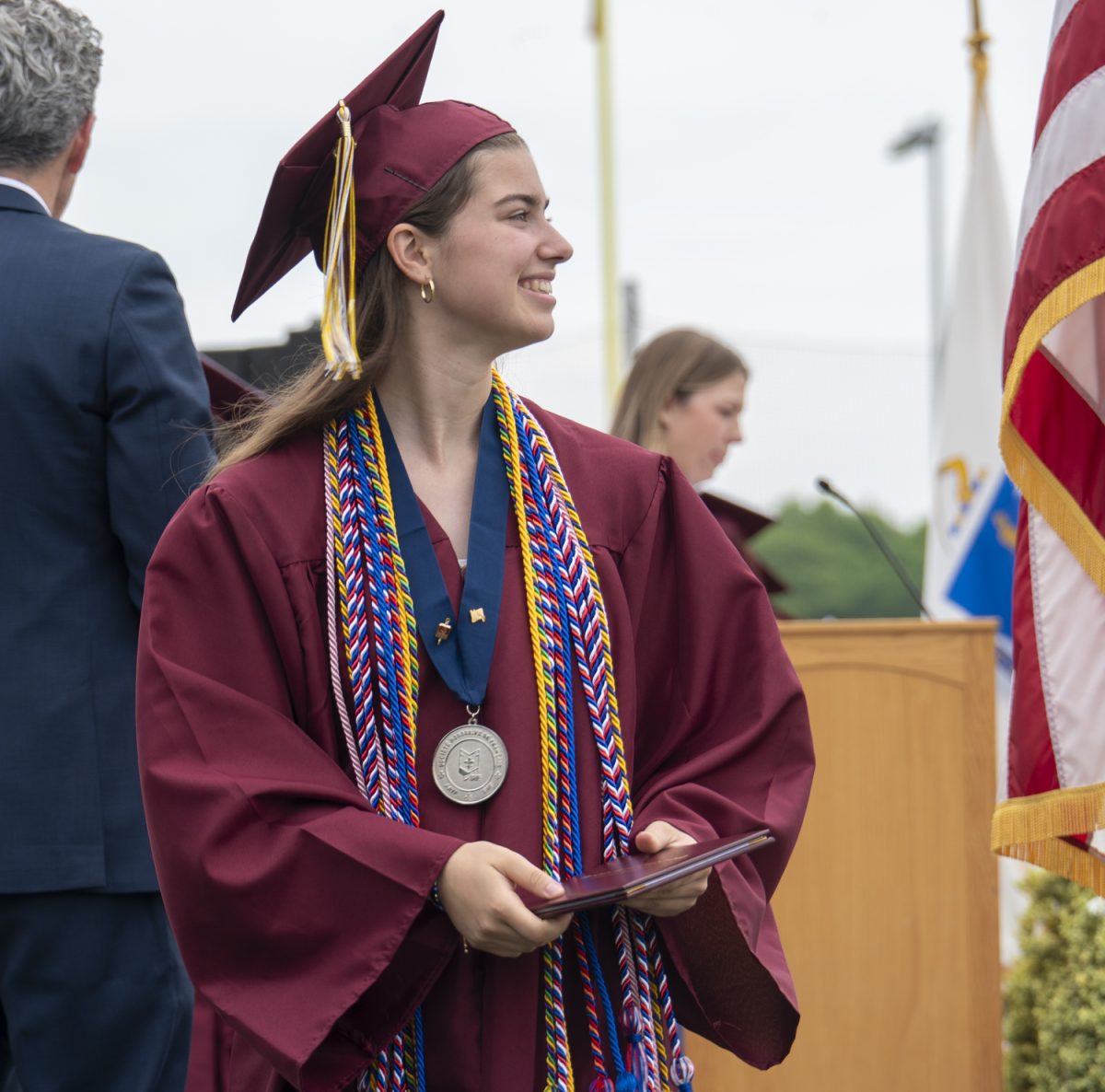 During graduation on June 6, senior Laura White smiles after walking the stage and accepting her diploma.