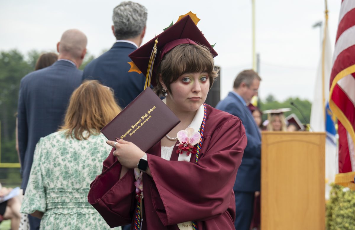 Senior Jaiden Leone shows off her diploma to family in the crowd after walking the stage at graduation on June 6.