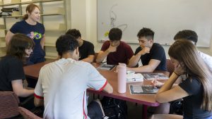 Students in the Portuguese Heritage class work on a crossword worksheet in the library. The class will be discontinued in the 26-27 school year due to low enrollment.