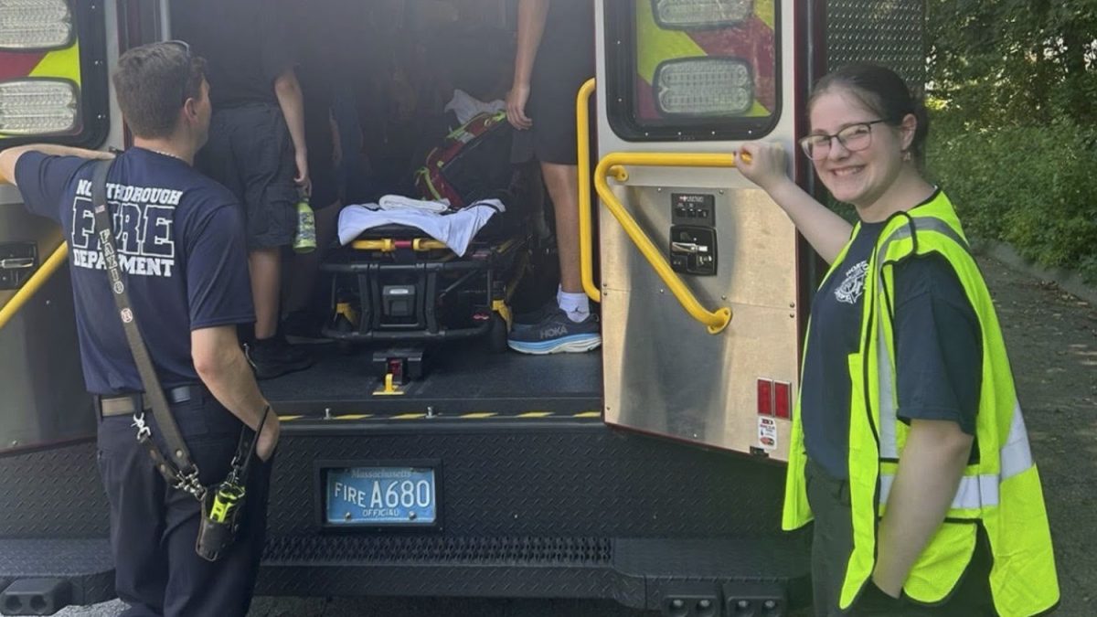 Recent graduate Liah Biran poses with a Northborough Fire Department ambulance during her EMT training.